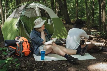 two men sitting and thinking about to get the tips to avoid back pain in camping